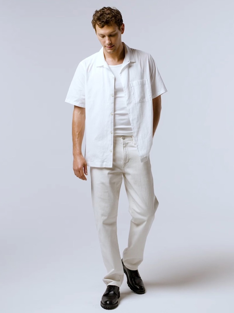 Cooper Koch wears a short-sleeve linen shirt, ribbed tank, and straight jeans. 