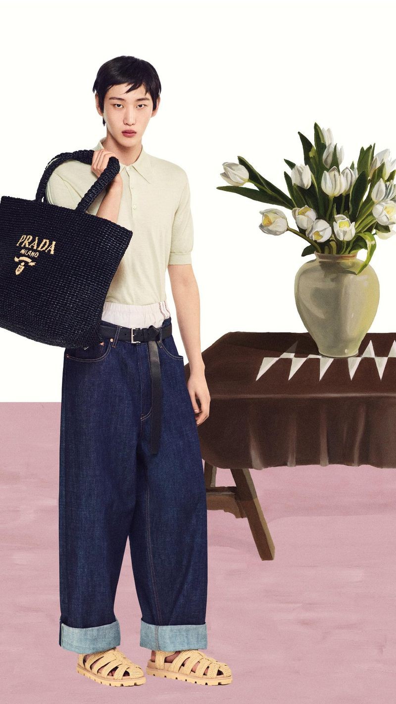 Hamin Yu wears a cashmere polo with jeans and a black crochet tote bag for Prada's summer 2024 campaign.